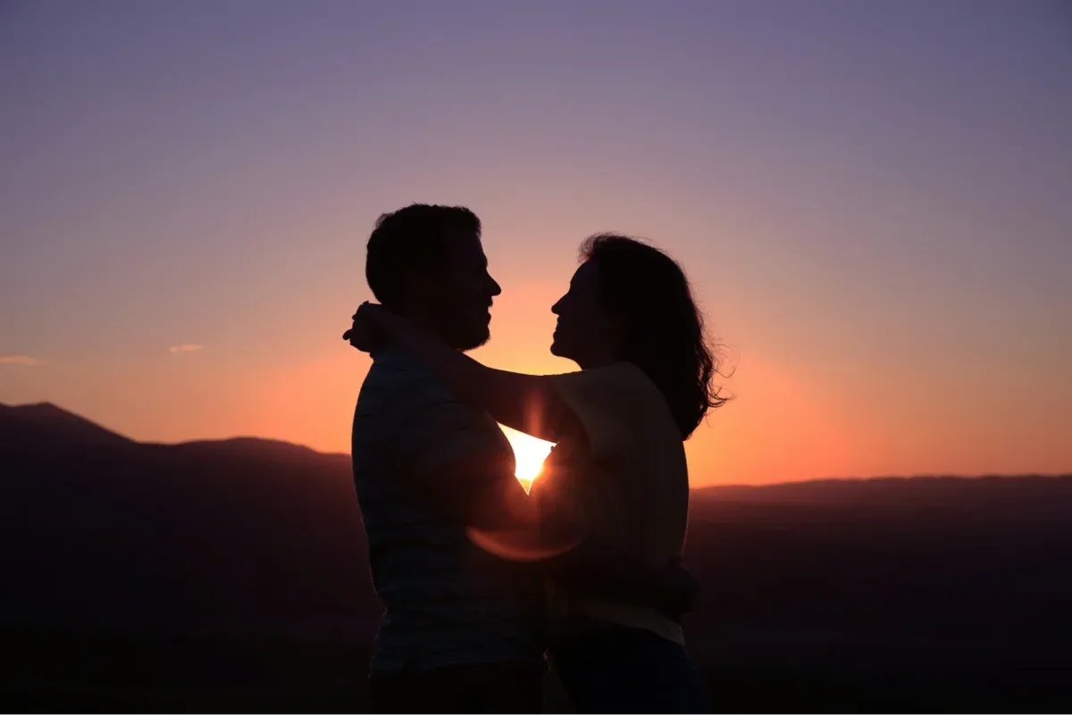 Romantic couple silhouette at sunset